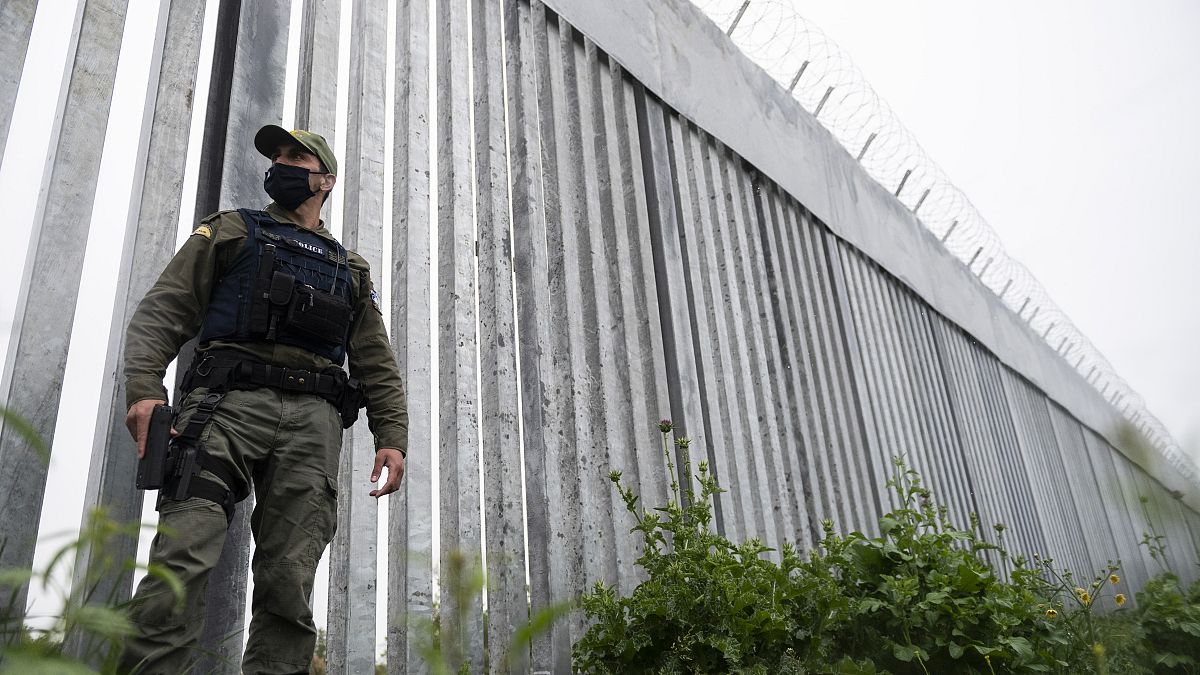 A police officer patrols alongside a steel wall at Evros river, near the village of Poros, at the Greek -Turkish border, Greece