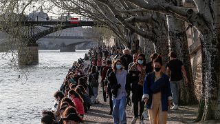 Parisians enjoy a stroll along the Seine river bank in March