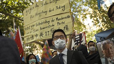 Hong Kong activist Nathan Law, centre, taking part in an anti-Beijing protest in Berlin, Germany. Hong Kong activist Nathan Law, centre, taking part in an anti-Beijing protest in Berlin, Germany.