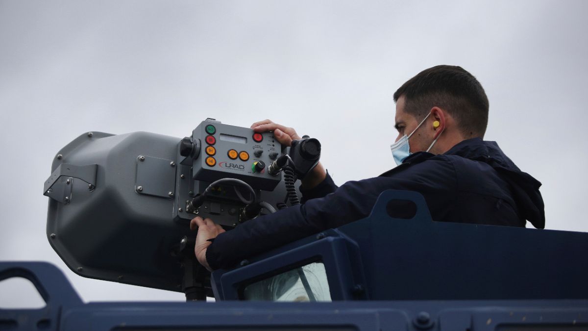 Police officer Dimitris Bistinas operates a long range acoustic device attached on a police vehicle along the Greek-Turkish border near the town of Feres May 21, 2021.