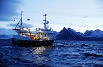 This is a Jan 1 2016 file photo of Jan Gunnar Johansen and Trond Dalgard as they fish for cod from the vessel Buaodden in the Norwegian Sea near Gryllefjord, northern Norway.