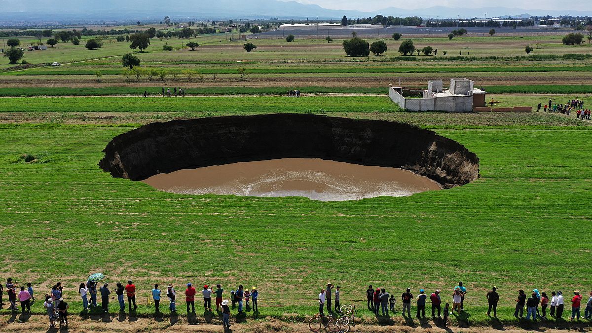 Aerial view of a sinkhole that was found by farmers in a field of crops in Santa Maria Zacatepec, state of Puebla, Mexico. May 30, 2021