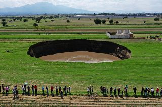 Aerial view of a sinkhole that was found by farmers in a field of crops in Santa Maria Zacatepec, state of Puebla, Mexico. May 30, 2021