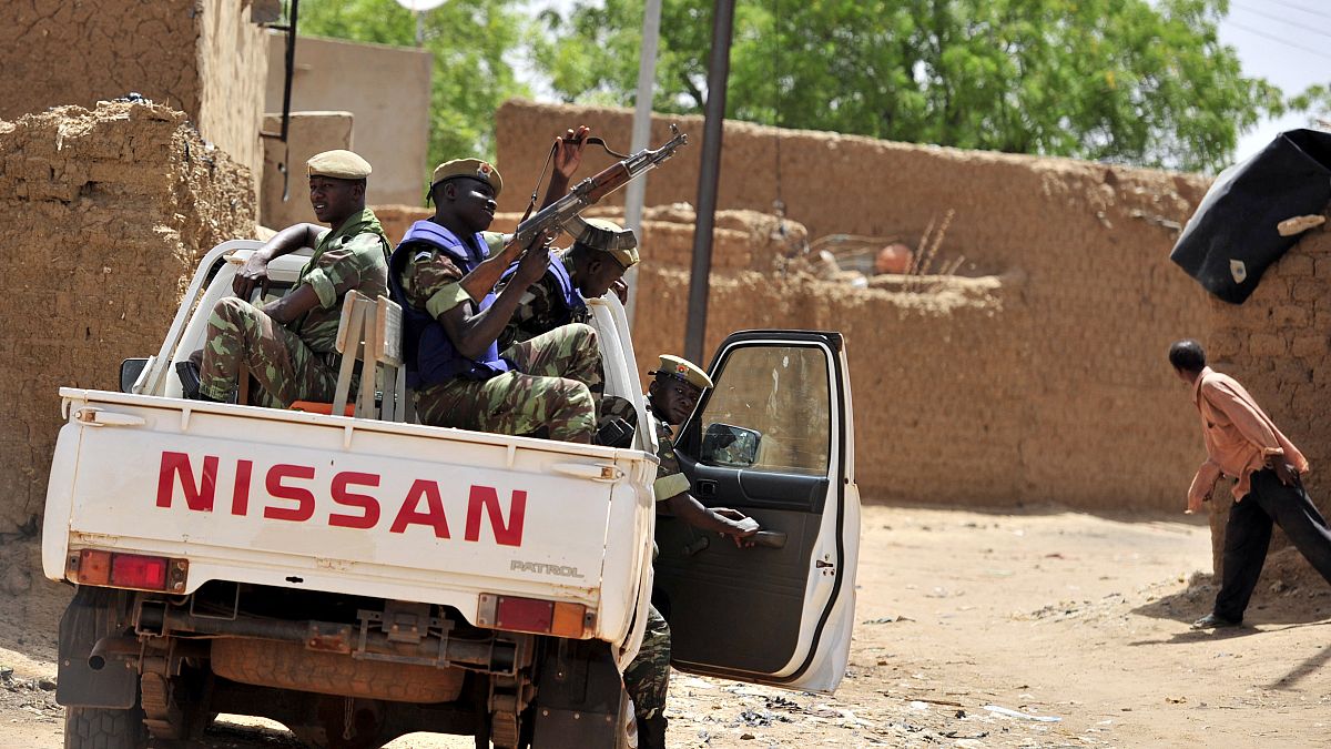In this file photograph taken on June 27, 2012, Burkinabe soldiers patrol in a pick-up car in Gorom-Gorom, northern Burkina Faso. 