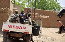 In this file photograph taken on June 27, 2012, Burkinabe soldiers patrol in a pick-up car in Gorom-Gorom, northern Burkina Faso. 