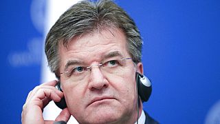 In this file photo dated Tuesday, Feb. 18, 2020, Slovakia's Foreign Minister Miroslav Lajcak adjusts his headphones during a press conference in Bucharest, Romania. 