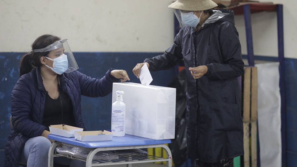 A voter casts her ballot during a run-off presidential election in Lima, Peru, Sunday, June 6, 2021.