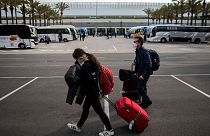 Passengers wearing face masks arrive at Palma de Mallorca Airport on the Spanish Balearic Island of Mallorca, Spain, Saturday, March 27, 2021.