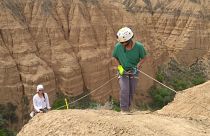 Charlotte Prud'homme (pictured left) abseiling to collect soil samples.