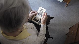 anziana donna che guarda una sua foto da giovene anziana donna che guarda una sua foto da giovene