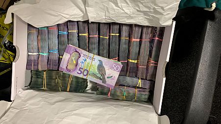 This undated photo from New Zealand police shows a box containing a large amounts of cash after being discovered during a police raid as part of Operation Trojan.