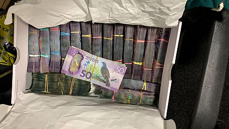 This undated photo from New Zealand police shows a box containing a large amounts of cash after being discovered during a police raid as part of Operation Trojan.