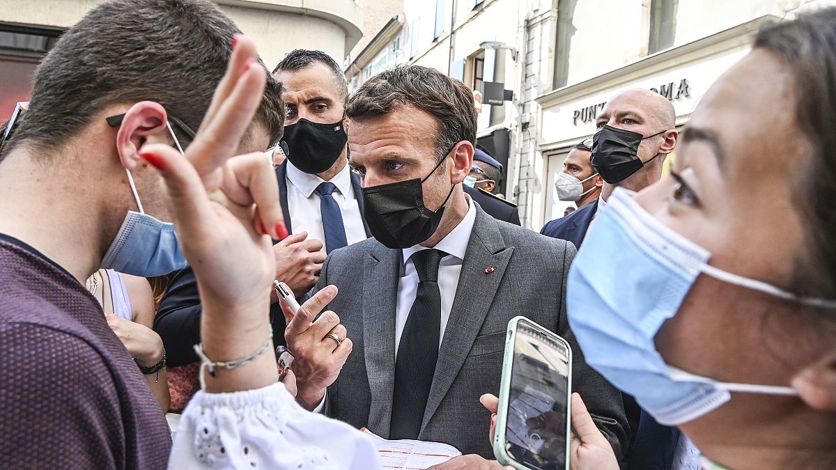 French President Emmanuel Macron talks to residents Tuesday June 8, 2021 in Valence