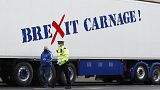Jan, 18, 2021, a policeman escorts the driver of a shellfish export truck as he is stopped for an unnecessary journey in London.