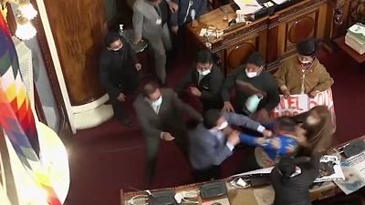 Brawl between congressman Antonio Gabriel Colque (blue suit) from Movement to Socialism and Senator Henry Montero (grey suit) from We Believe party