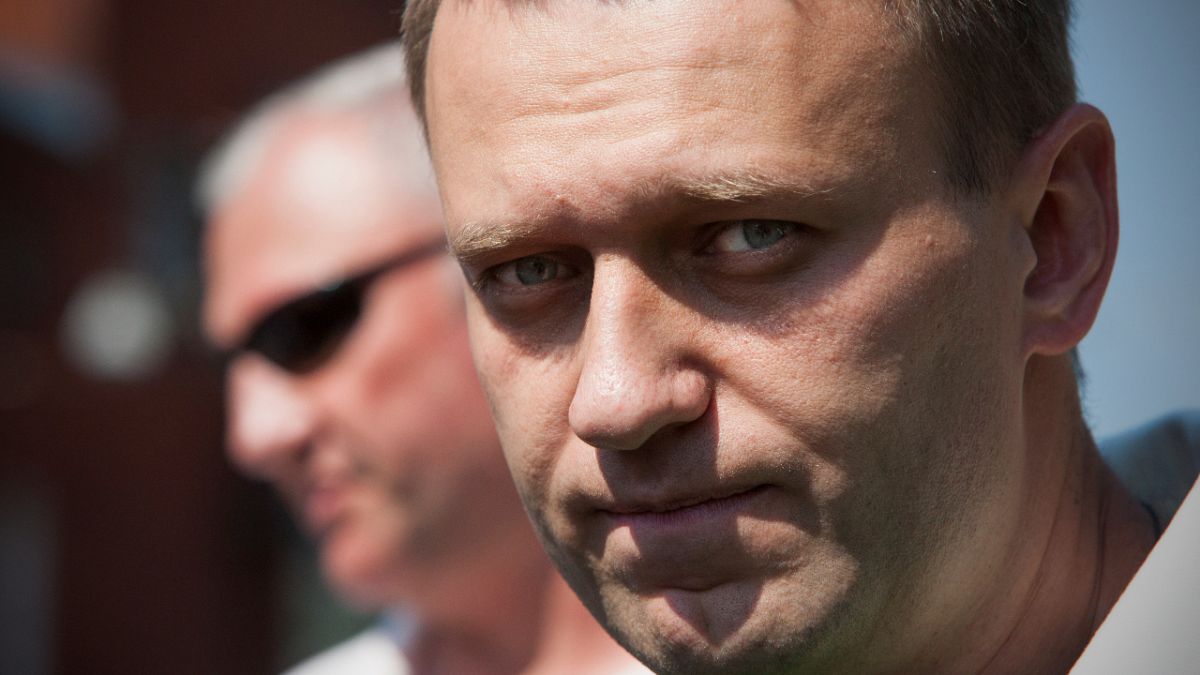 Russian protest leader Alexei Navalny leaves the headquarters of the Russian Investigation committee in Moscow, Russia, Friday, Aug. 3, 2012.