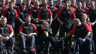 FILE - Britain's Prince Harry poses with the team during the announcement of the British Armed Forces team for the Invictus Games in London, Wednesday, Aug. 13, 2014