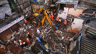 Rescuers clear the debris to find any residents possibly still trapped after a building collapsed following heavy monsoon rains n Mumbai, India, June 10, 2021.