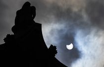 The partially eclipsed sun beside Nelson's Column in Trafalgar Square in London, Thursday, June 10, 2021.