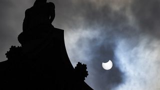 The partially eclipsed sun beside Nelson's Column in Trafalgar Square in London, Thursday, June 10, 2021. 