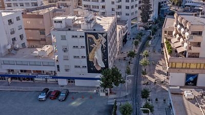 A mural by Greek artist Fikos, who describes himself as a "neo-muralist", is pictured on a building on Stasikratous Street