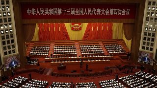 Delegates attend the opening session of China's National People's Congress (NPC) at the Great Hall of the People in Beijing on March 5, 2021.