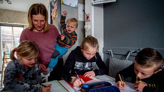 A mother homeschools her children amid a spike in parents opting to home-educate in the UK