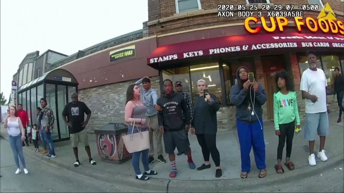Police body camera shows Darnella Frazier, third from right filming, as former Minneapolis police officer Derek Chavin pressed his knee on George Floyd's neck May 25, 2020