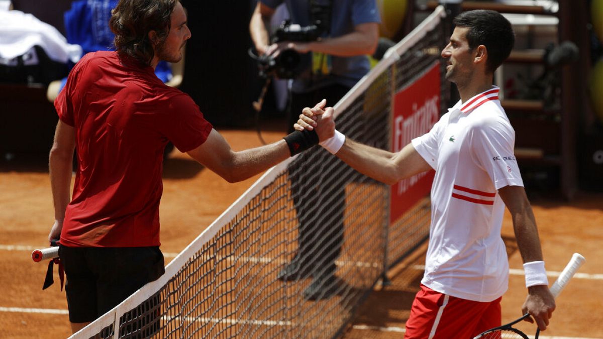 Serbia's Novak Djokovic greets Greece's Stefanos Tsitsipas, left