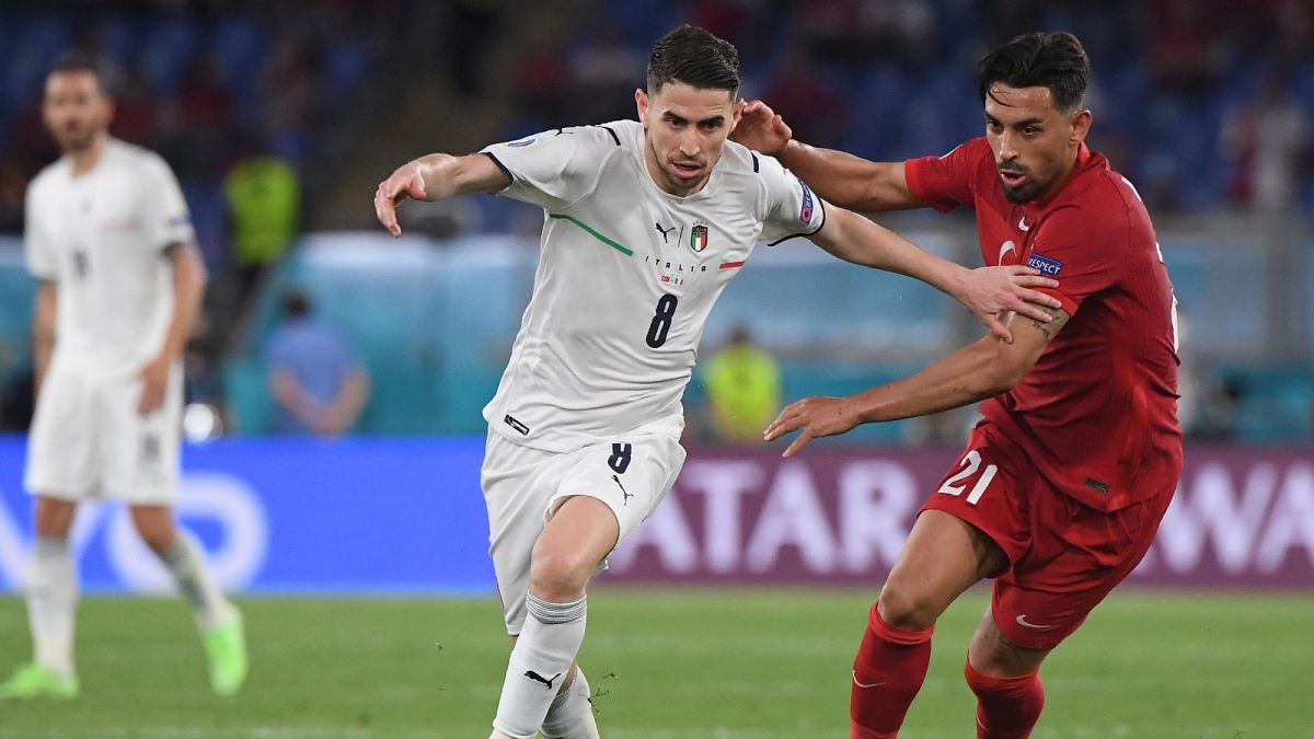Italy's Jorginho, left, fights for the ball with Turkey's Irfan Kahveci during the first Euro 2020 match at the Olympic stadium in Rome, Friday, June 11, 2021