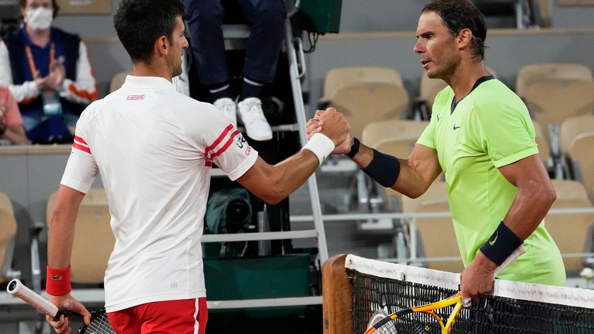 Serbia's Novak Djokovic, left, shakes hands with Spain's Rafael Nadal after their French Open semifinal, Paris, June 11, 2021. Djokovic won 3-6, 6-3, 7-6 (4), 6-2. 