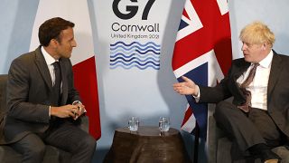 Britain's Prime Minister Boris Johnson and France's President Emmanuel Macron take part in a bilateral meeting during the G7 summit in Carbis bay, Cornwall on June 12, 2021.