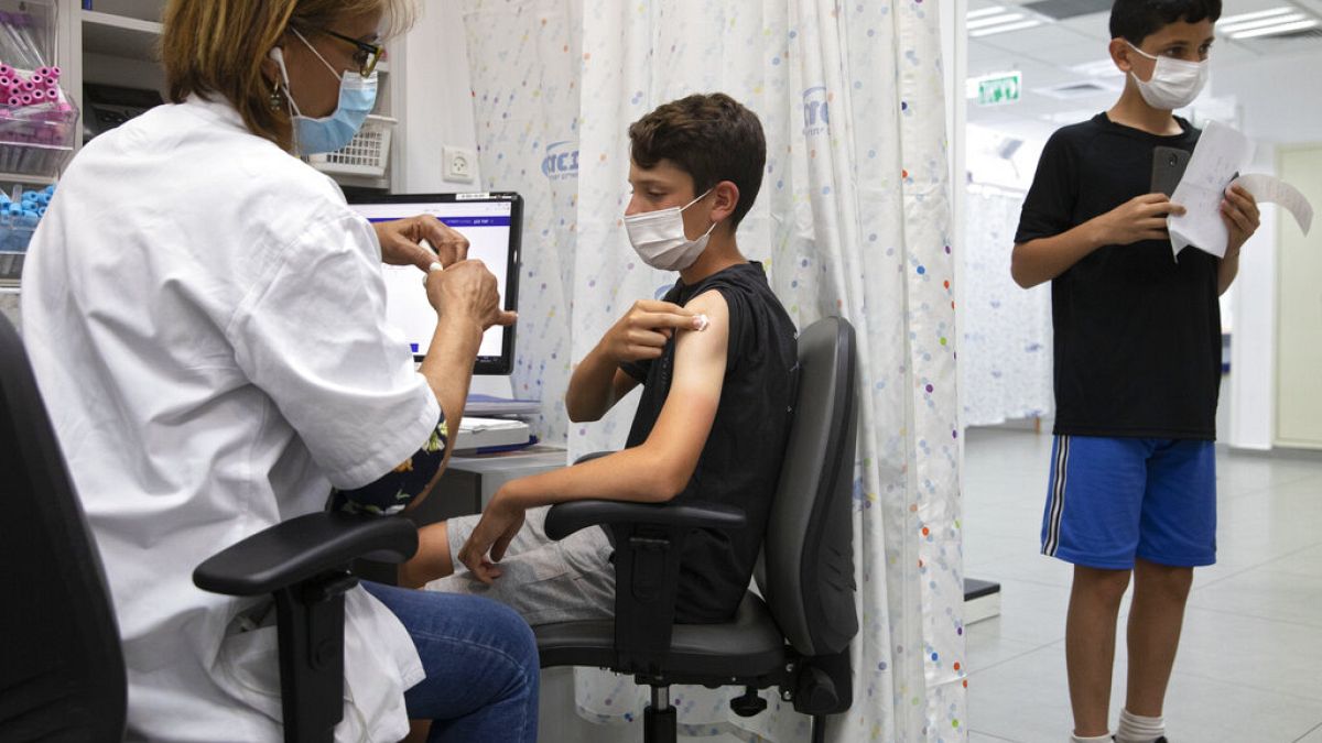 An Israeli youth receives a Pfizer-BioNTech COVID-19 vaccine in the central Israeli city of Rishon LeZion,