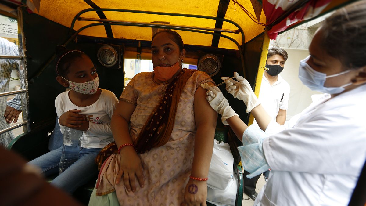 A physically disabled woman gets a dose of Covishield, Serum Institute of India's version of the AstraZeneca COVID-19 vaccine, in Ahmedabad, India, Saturday, June 12, 2021.