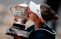 Czech Republic's Barbora Krejcikova kisses the trophy after defeating Russia's Anastasia Pavlyuchenkova in the French Open final at Roland Garros, June 12, 2021.
