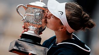 Czech Republic's Barbora Krejcikova kisses the trophy after defeating Russia's Anastasia Pavlyuchenkova in the French Open final at Roland Garros, June 12, 2021.