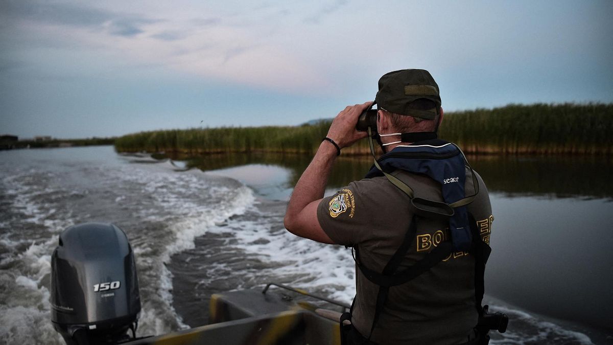 ضابط شرطة يقوم بدوريات في نهر إيفروس على متن قارب على طول الحدود اليونانية التركية، 8 يونيو 2021
