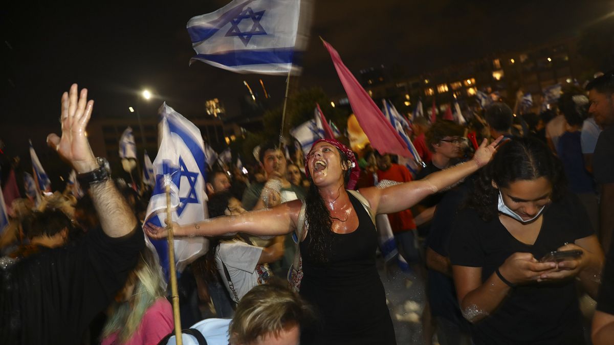 Israelis celebrate the swearing in of the new government in Tel Aviv