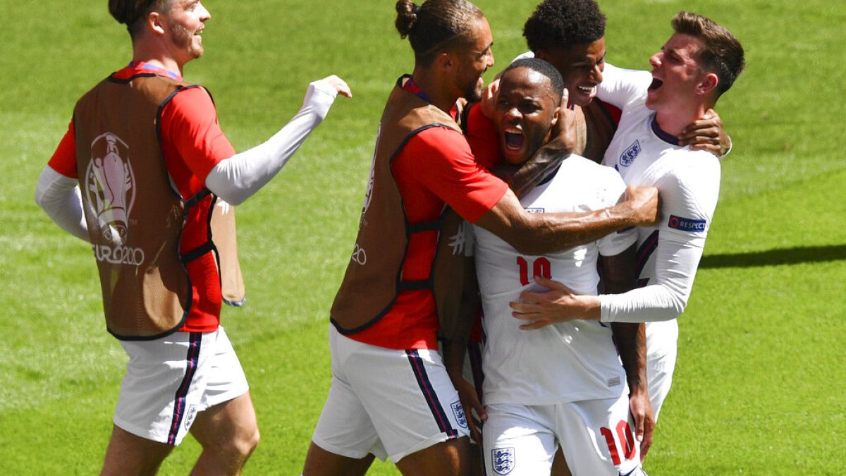 England's Raheem Sterling, centre, is congratulated by teammates after scoring his team's first goal during Euro 2020