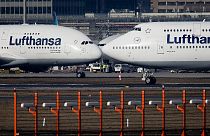Airbus A380, left, and a Boeing 747, both from Lufthansa airline pass each other at the airport in Frankfurt, Germany on Feb.14, 2019