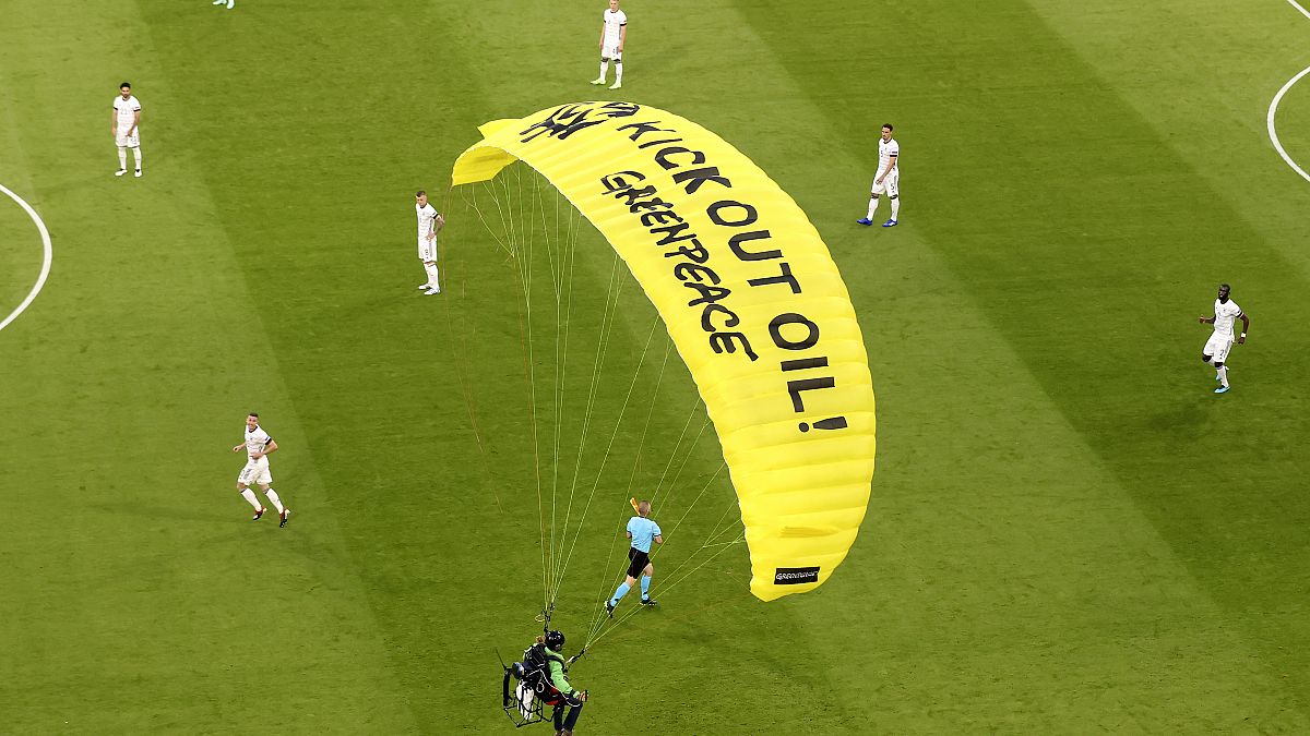 A Greenpeace paraglider lands at the Allianz Arena stadium in Munich prior to the Euro 2020 group F match between France and Germany, June 15, 2021.