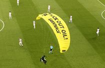 A Greenpeace paraglider lands at the Allianz Arena stadium in Munich prior to the Euro 2020 group F match between France and Germany, June 15, 2021