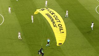 A Greenpeace paraglider lands at the Allianz Arena stadium in Munich prior to the Euro 2020 group F match between France and Germany, June 15, 2021