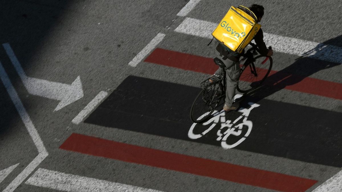 A delivery worker rides in Barcelona