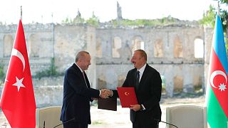 Turkish President Recep Tayyip Erdogan and Azerbaijani President Ilham Aliyev shake hands after signing "the Shusha Declaration" in Shusha, Nagorno-Karabakh, June 15, 2021.