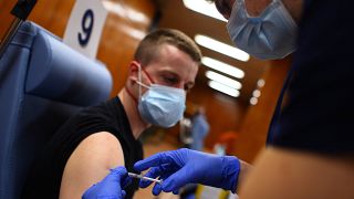 Egy férfi megkapja a koronavírus elleni oltást a szófiai Katonaorvosi Akadémián február 22-én