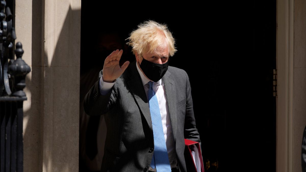 British Prime Minister Boris Johnson waves at the media as he leaves 10 Downing Street to attend the weekly Prime Minister's Questions in Parliament, London, June 16, 2021.