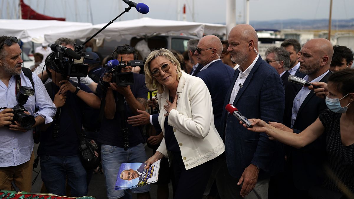 Far-right leader Marine Le Pen gestures as she campaigns at an open air market of Six-Fours-les-Plages, southern France, Thursday, June 17, 2021