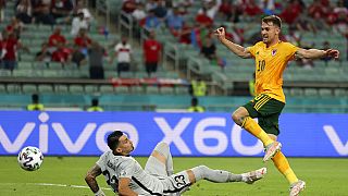 Wales' Aaron Ramsey, right, scores his sides first goal past Turkey's goalkeeper Ugurcan Cakir