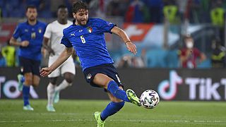 Italy's Manuel Locatelli, left, scores his side's first goal during the Euro 2020 soccer championship group A match between Italy and Switzerland at the Rome Olympic stadium, 